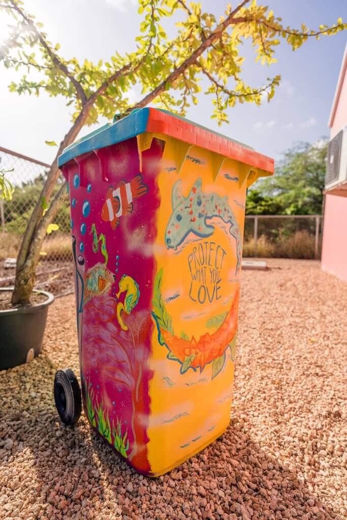 A trash bin with animals painted on it